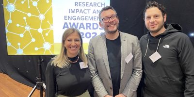 Francesca Giliberto, Alessandro Biraglia and Luca Sabini stood together in front of a screen that says 